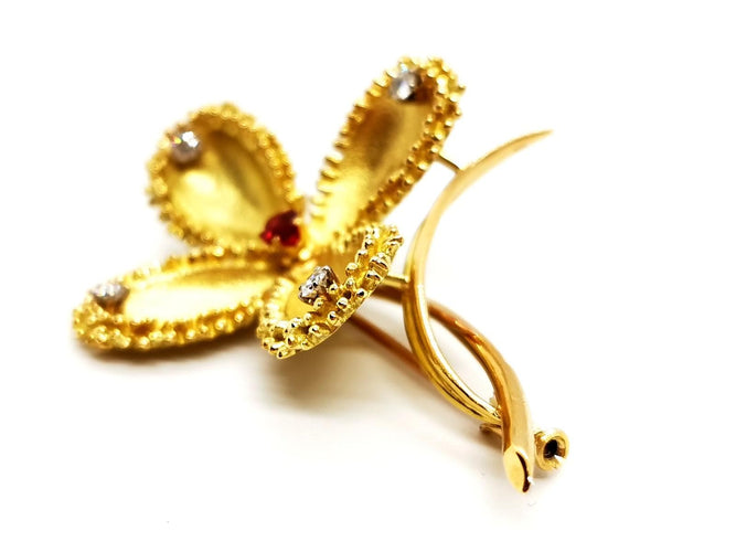 Broche Broche fleur vintage en or jaune 18 carats rubis et diamants 58 Facettes 1089906CD