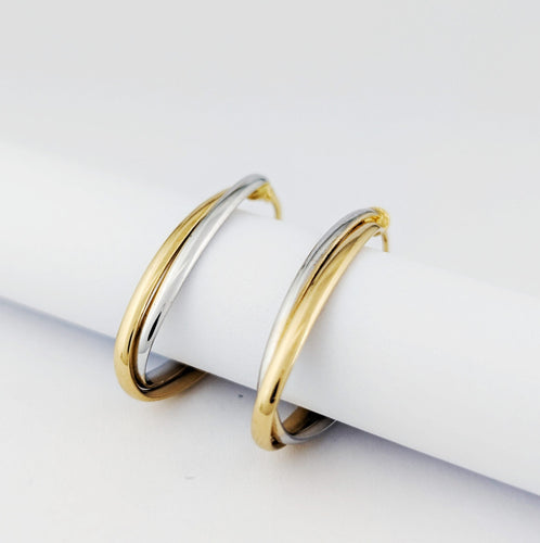 Boucles d'oreilles Créoles ovales torsadées en or blanc et jaune 18 carats 58 Facettes 33738