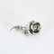 Broche Broche "Rose" en or blanc, émeraudes et diamant 58 Facettes DV0832-3