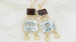 Boucles d'oreilles Boucles d'oreilles en or jaune 18 ct, aigue-marine et grenats 58 Facettes 31504
