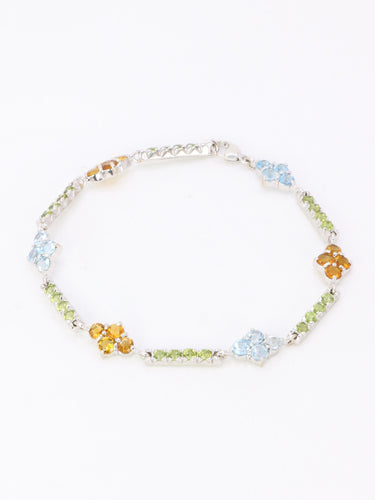 Bracelet Bracelet ligne en or blanc 18 carats avec citrines, péridots et topazes bleues 58 Facettes 1CA0000006/1