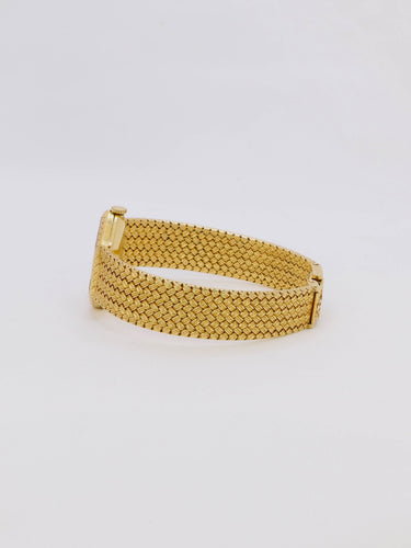 Montre Baume & Mercier - Montre vintage en or jaune 18 carats à maille tressée 58 Facettes 1067.3