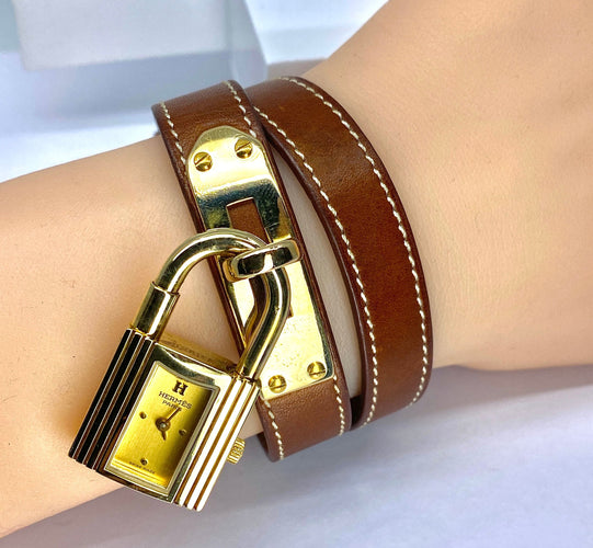 Montre Montre Hermès «  Kelly », cadran PM plaqué or, double tour cuir marron 58 Facettes AB453