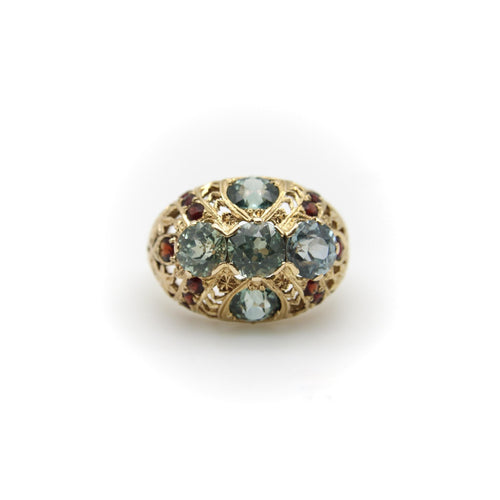 Bague Bague bombée en or avec topaze bleue victorienne et grenat 58 Facettes A20050