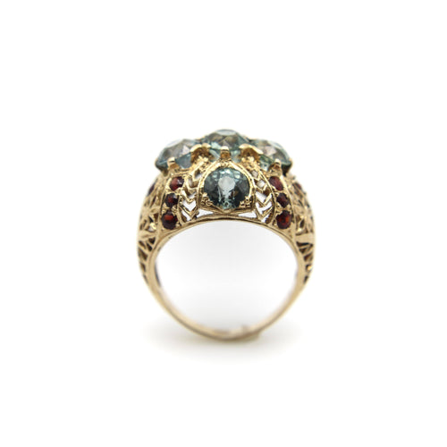 Bague Bague bombée en or avec topaze bleue victorienne et grenat 58 Facettes A20050