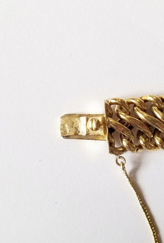 Bracelet Bracelet maille américaine or jaune 18 carats et breloques - 17 cms - 36.25 grs 58 Facettes