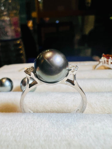 Bague 56 Bague en or sertie d'une perle de culture grise entourée de 2 diamants 58 Facettes 2920 A