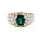 Bague or jaune, émeraude ovale et pavage diamants.