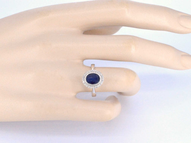 Bague 54 Bague entourage en or blanc avec diamants et saphir 58 Facettes 2044