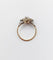 Bague 48 Bague fleur art deco or rose 18k ornée d'un diamant taille brillant entouré de rubis calibrés dans une monture finement travaillée (circa 1920) 58 Facettes A04432