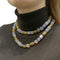 Collier Sautoir cubes de calcédoine et motifs en or jaune. 58 Facettes 35267