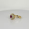 Bague Bague entourage en or jaune et blanc avec rubis ovale et diamants 58 Facettes 2212038