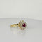 Bague Bague entourage en or jaune et blanc avec rubis ovale et diamants 58 Facettes 2212038