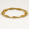 Bracelet Bracelet en or jaune à motif de fleurs et de feuilles ciselées 58 Facettes MON1100X2