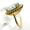 Bague 55 Bague en or jaune de haute joaillerie ornée d'une aigue-marine et d'un halo de diamants 58 Facettes 50357