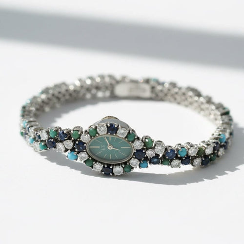 Montre Uti - Montre Ovale - Or Blanc - Diamants, Saphirs et Turquoise 58 Facettes 1.0001001/1