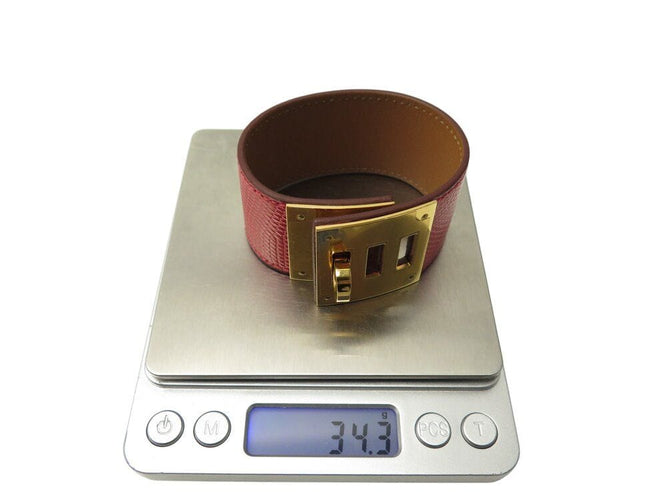 Bracelet bracelet HERMES kelly chien lézard niloticus t3 15 a 17 métal doré rouge 58 Facettes 267512