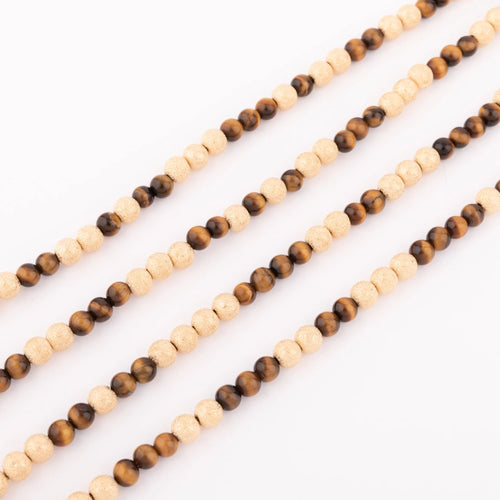 Collier Sautoir en perles d'or ciselés et perle yeux de tigre 58 Facettes 1