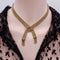 Collier collier en or tressé avec fermoir à boucle et pompons 58 Facettes