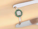 Bague en or blanc avec diamants et émeraude