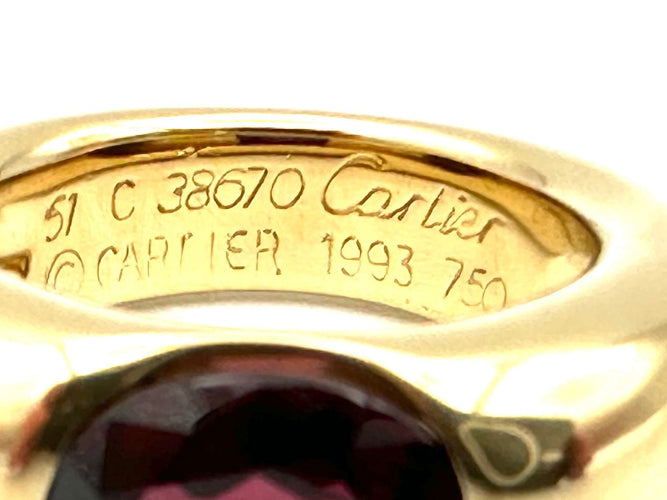Bague 51 CARTIER. Collection "Ellipse", bague or jaune et grenat 58 Facettes