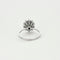 Bague 57 Bague marguerite en or gris, émeraude et diamants 58 Facettes