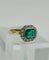 Bague Bague en or jaune et platine, ornée d'une émeraude centrale et d'un halo de diamants. Style Art déco. 58 Facettes 50243