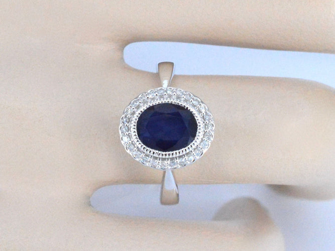 Bague 54 Bague entourage en or blanc avec diamants et saphir 58 Facettes 2044