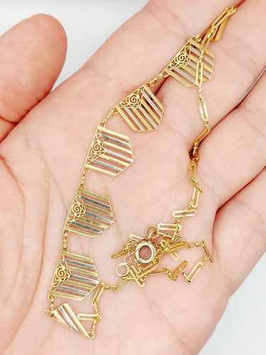 Collier Collier Art déco à motifs filigranés en or jaune et blanc 18k 58 Facettes A04100