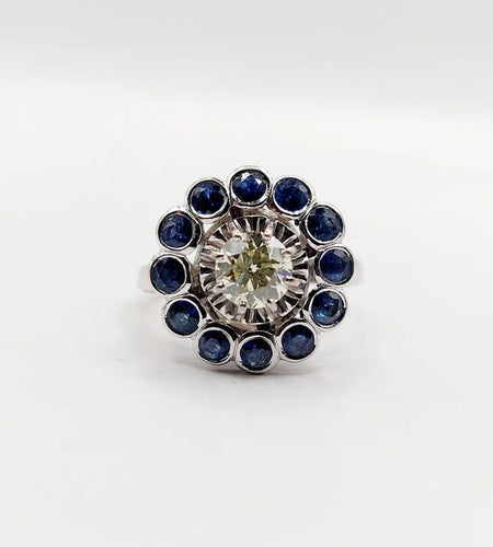 Bague 51.5 Art déco - Bague marguerite en or blanc 18k, diamant 0,65 ct et saphirs 58 Facettes A06329