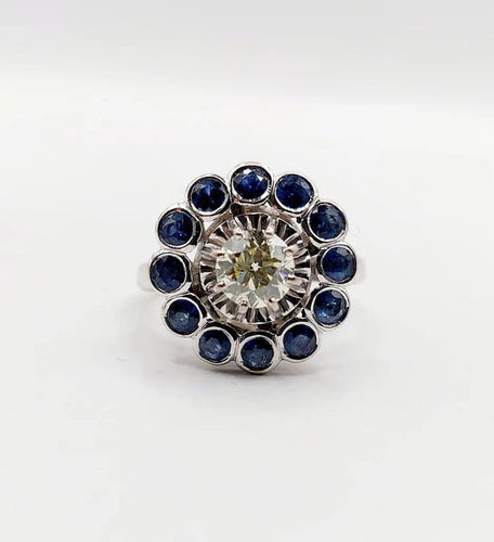 Bague 51.5 Art déco - Bague marguerite en or blanc 18k, diamant 0,65 ct et saphirs 58 Facettes A06329
