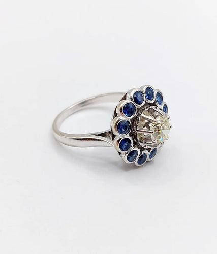 Bague 51.5 Art déco - Bague marguerite en or blanc 18k, diamant 0,65 ct et saphirs 58 Facettes A06329