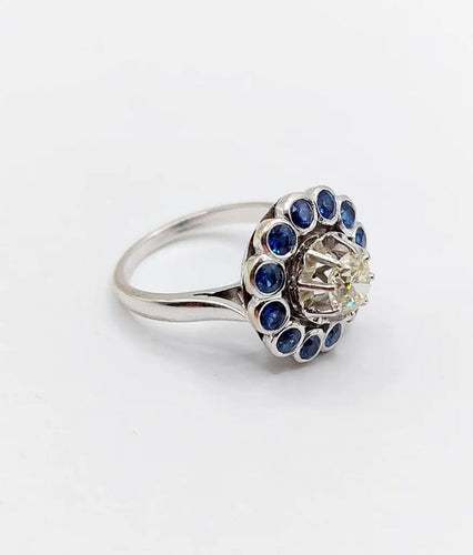 Bague 51.5 Art déco - Bague marguerite en or blanc 18k, diamant 0,65 ct et saphirs 58 Facettes A06329