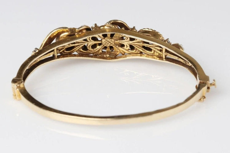 Bracelet Bracelet rigide ancien en or jaune 14 carats avec rubis, perles et diamants 58 Facettes 10673
