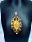 Pendentif Broche pendentif en or 18 carats aux grenats, émeraude et diamants 58 Facettes A 397
