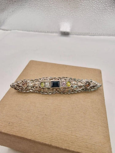Broche Broche vintage en or blanc 18 carats sertie de diamants et saphir 58 Facettes