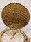 Montre Baume & Mercier - Broche montre en or jaune 18 carats et émail 58 Facettes
