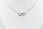 Collier Collier motif infini en or blanc 18 carats et diamants 58 Facettes 240410