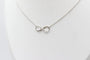Collier Collier motif infini en or blanc 18 carats et diamants 58 Facettes 240410