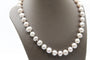 Collier Collier en or jaune et perles grises 58 Facettes 240134