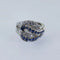 Bague 53 Bague entrelacée en or gris, saphirs et diamants 58 Facettes