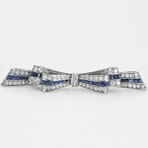 Broche Broche ruban en platine - Diamants et saphirs calibrés 58 Facettes YD4
