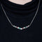 Collier Collier en or blanc 18 carats avec rubis, émeraudes et diamants 58 Facettes 1056180