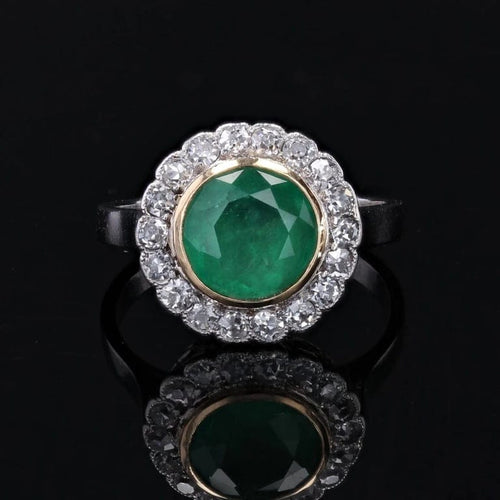 Bague 50 Bague ancienne ronde en platine et or jaune 18 carats, émeraude et diamants 58 Facettes 22-426