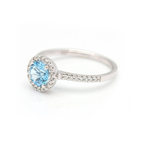 Bague Bague halo en or blanc 18 kt avec diamants et topaze bleue 58 Facettes UKD359674LF