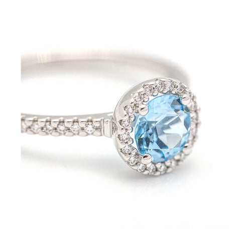 Bague Bague halo en or blanc 18 kt avec diamants et topaze bleue 58 Facettes UKD359674LF