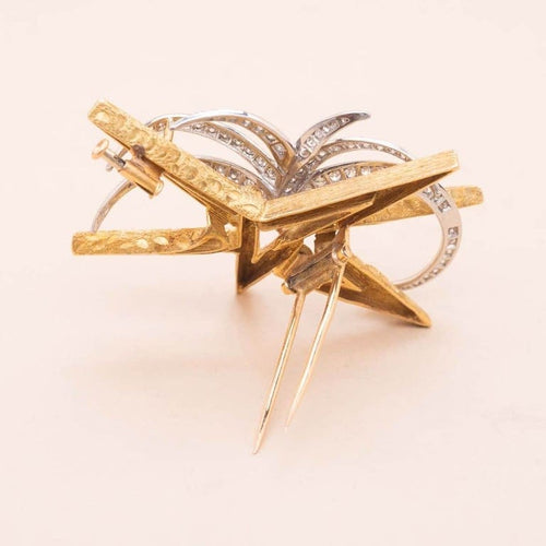 Broche Boucheron Starlight - Broche étoile en or jaune et platine diamants 58 Facettes 793350