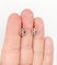 Boucles d'oreilles Dormeuses marguerite antiques en or rose 18k, platine, rubis synthétiques et diamants 58 Facettes A06712