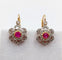 Boucles d'oreilles Dormeuses marguerite antiques en or rose 18k, platine, rubis synthétiques et diamants 58 Facettes A06712