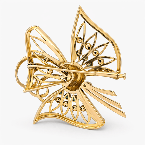 Broche Broche nœud stylisé en or jaune 18 carats, diamants et émeraudes 58 Facettes 36314